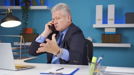 Aggressive-businessman-talking-on-the-phone-angrily.